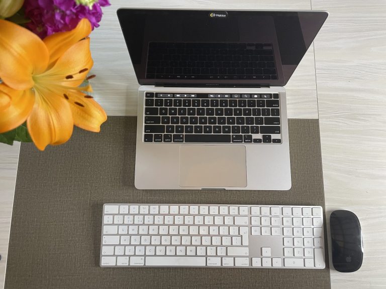 Laptop on a desk with flowers