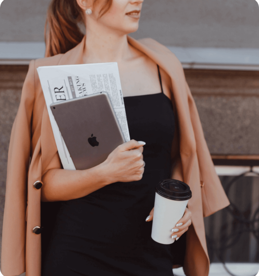 Woman holding laptop, coffee and coffee
